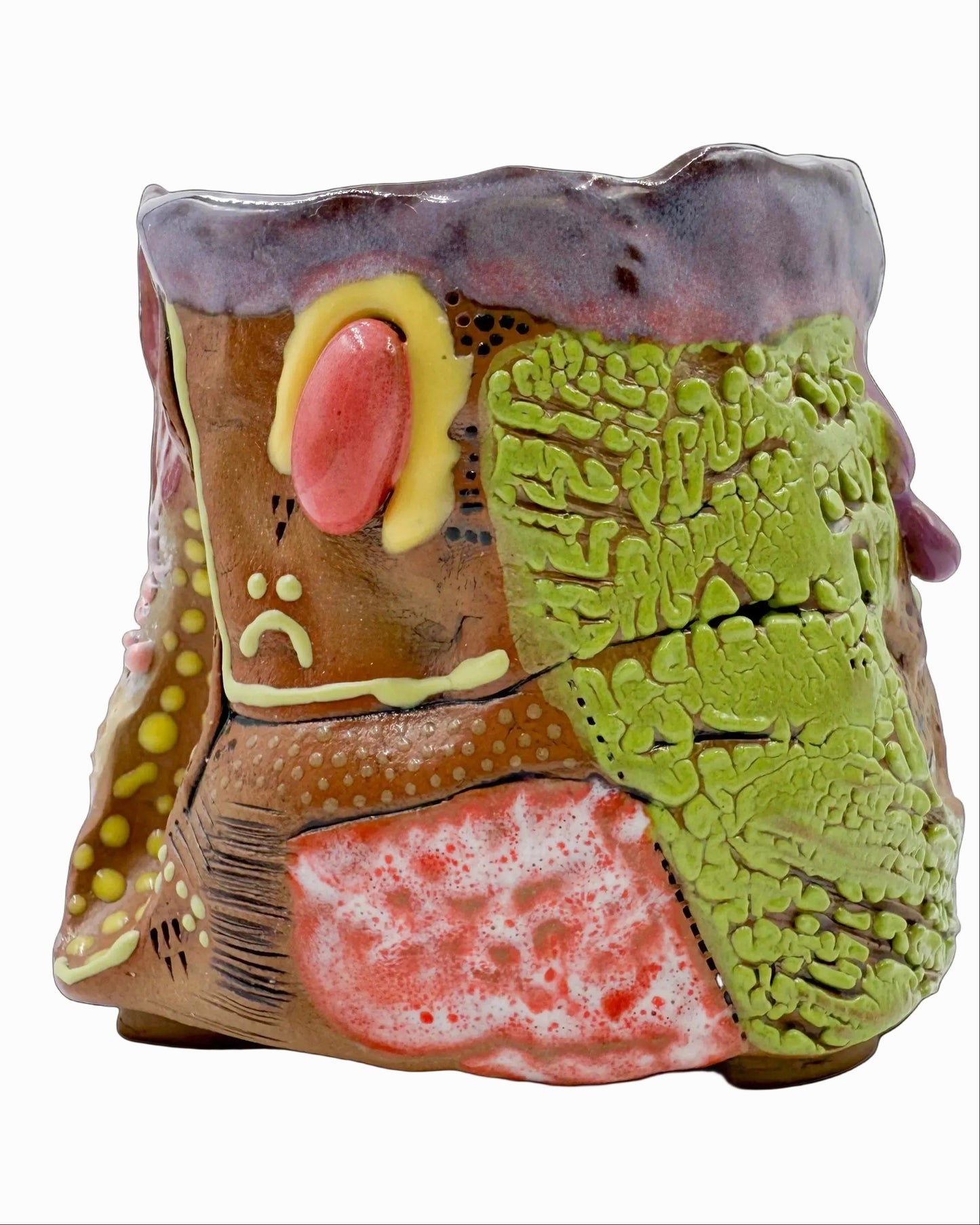 Pictured is a handmade ceramic mug that is full of gloops and globs allowing the mug holder to have a tactile experience while enjoying their preferred drink.