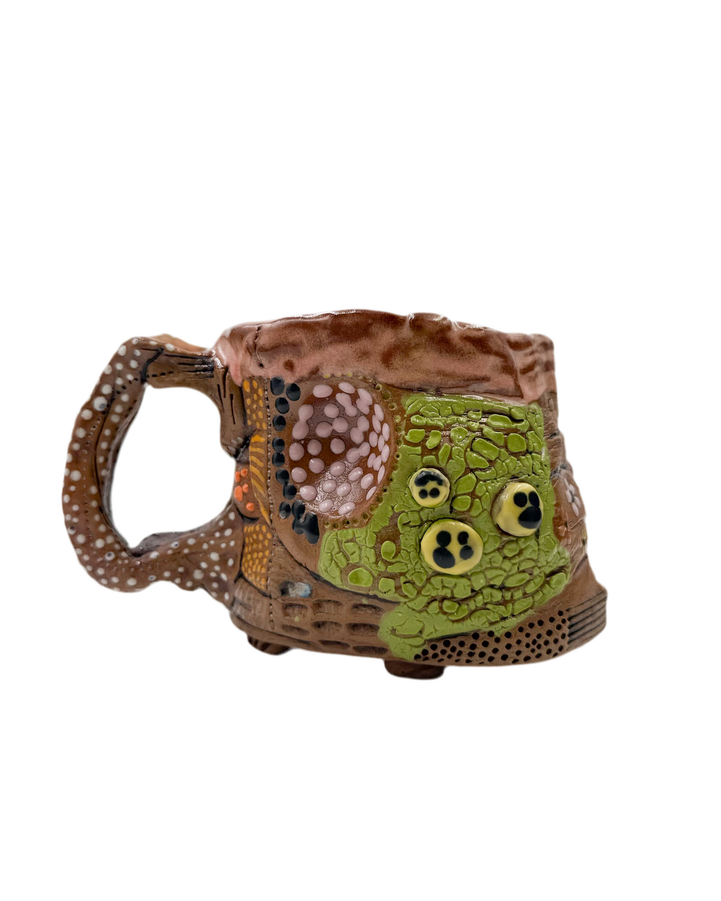 Pictured is a handmade ceramic mug that is full of gloops and globs allowing the mug holder to have a tactile experience while enjoying their peferred drink.