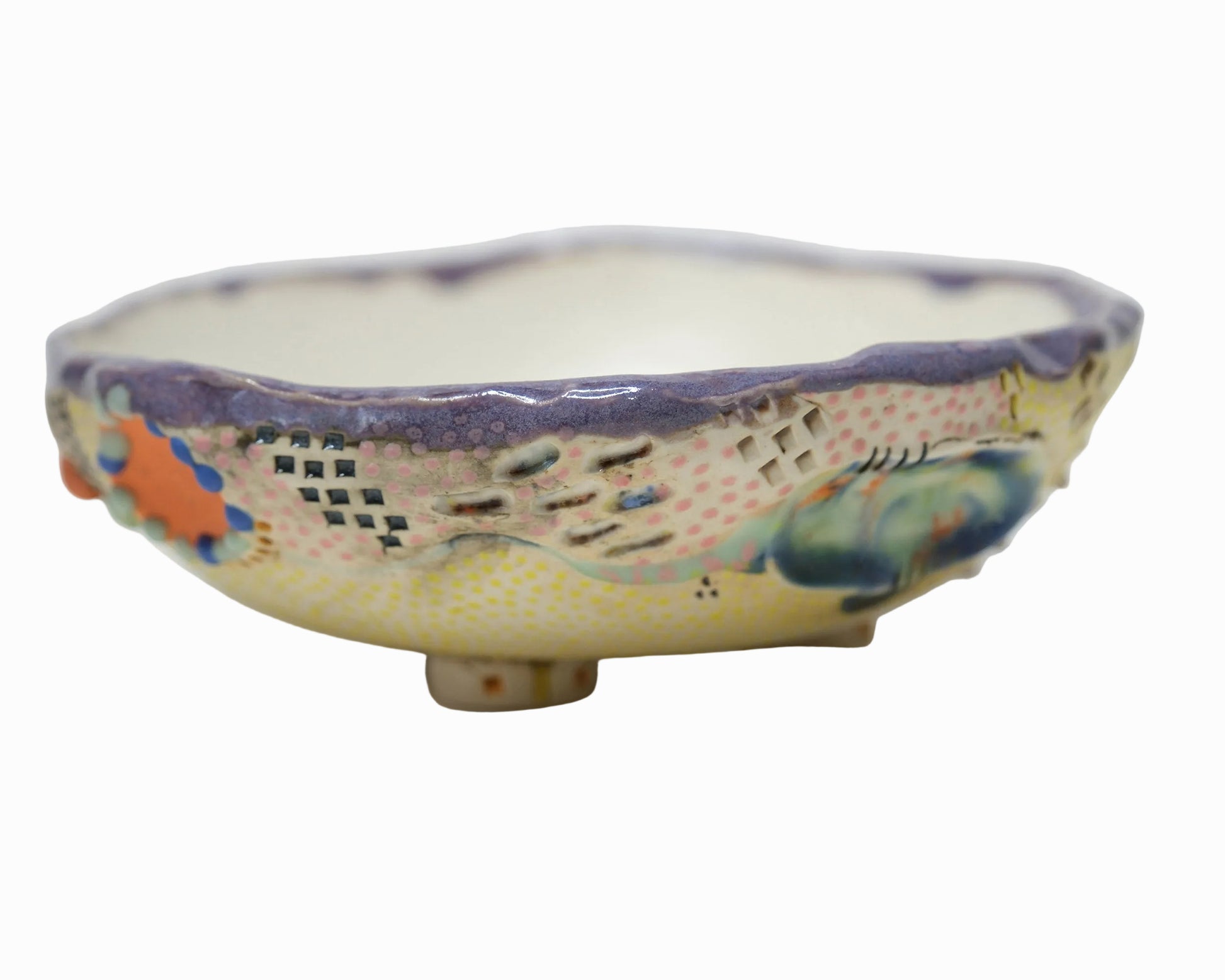 Decorative ceramic bowl with colorful patterns on a white background