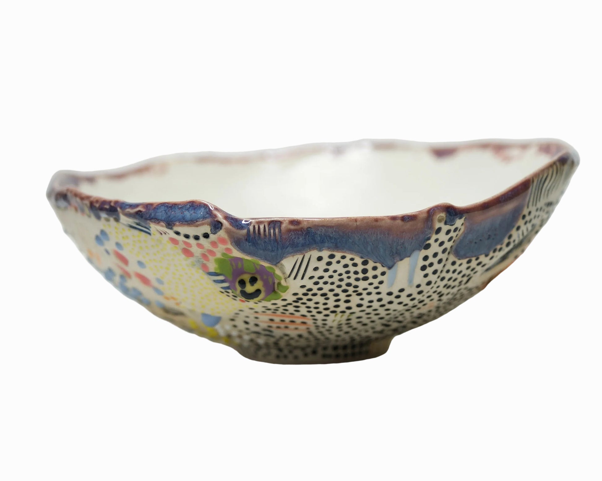 Decorative ceramic bowl with multicolored patterns on a white background