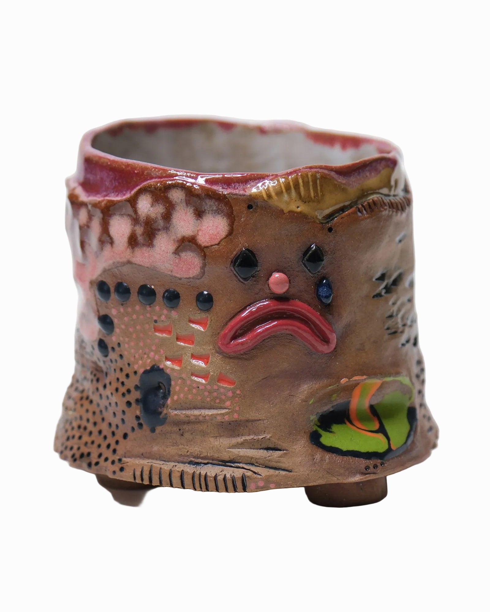 Pictured is a handmade ceramic mug that is full of gloops and globs allowing the mug holder to have a tactile experience while enjoying their preferred drink.
