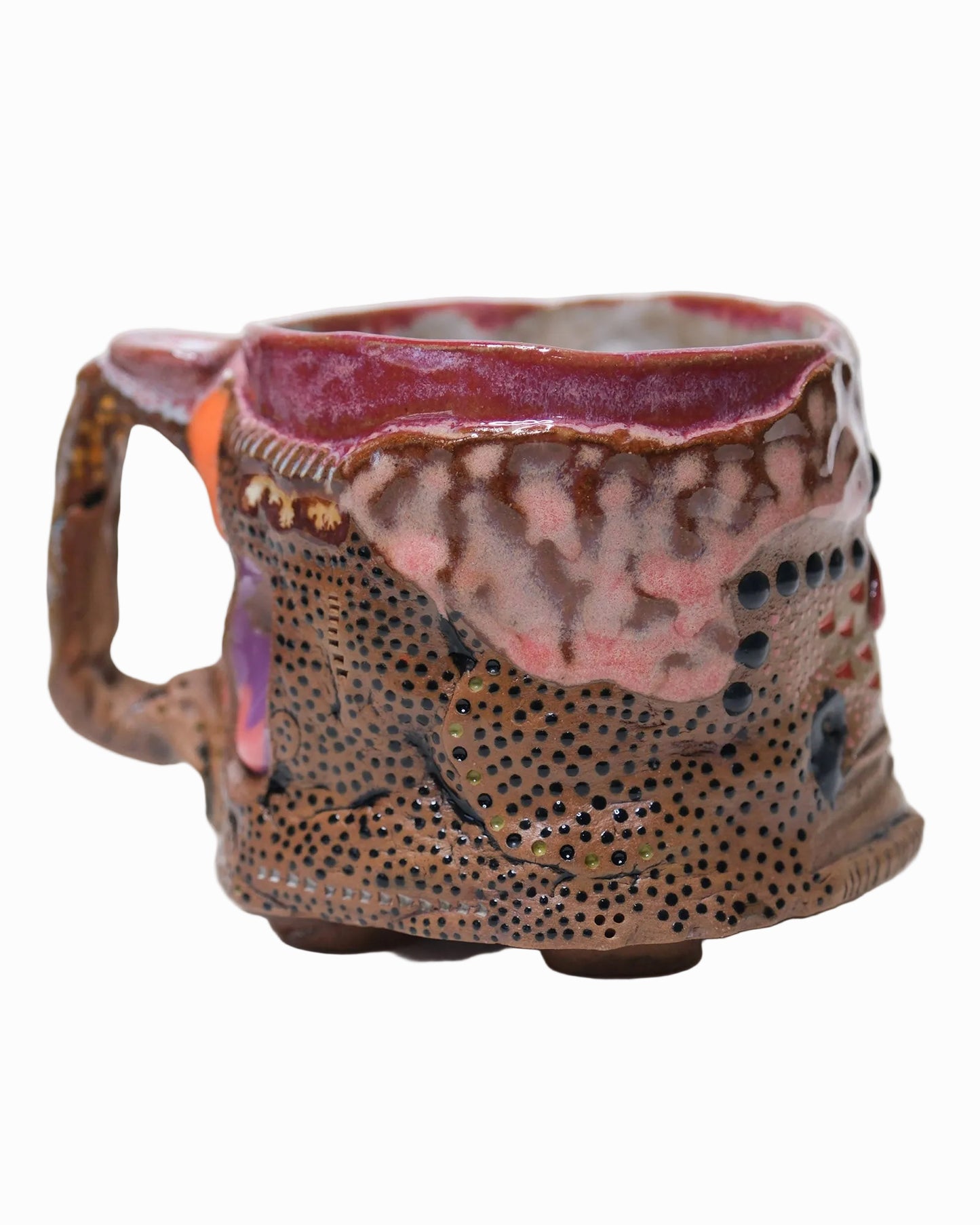 Pictured is a handmade ceramic mug that is full of gloops and globs allowing the mug holder to have a tactile experience while enjoying their preferred drink.
