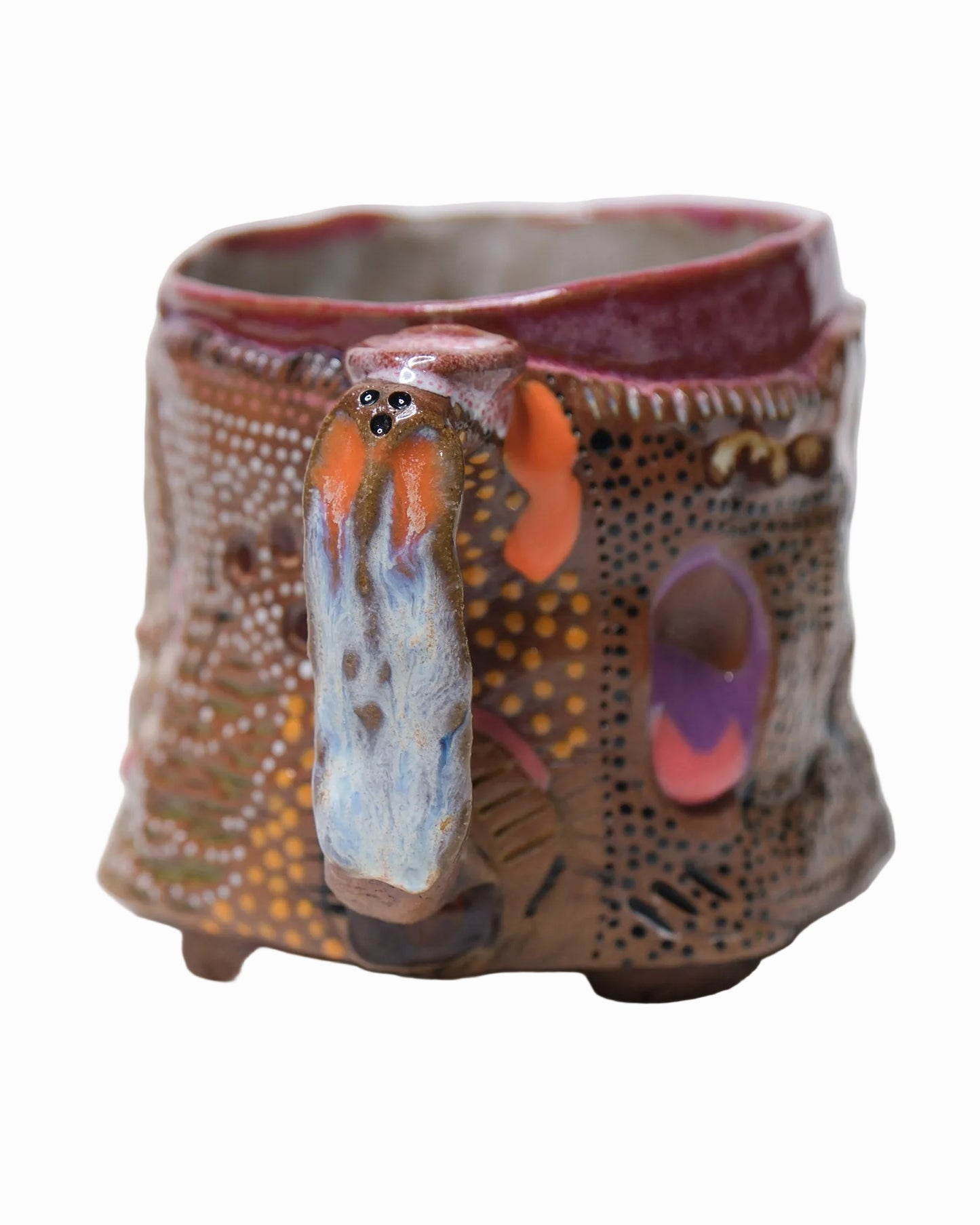Pictured is a handmade ceramic mug that is full of gloops and globs allowing the mug holder to have a tactile experience while enjoying their preferred drink.
