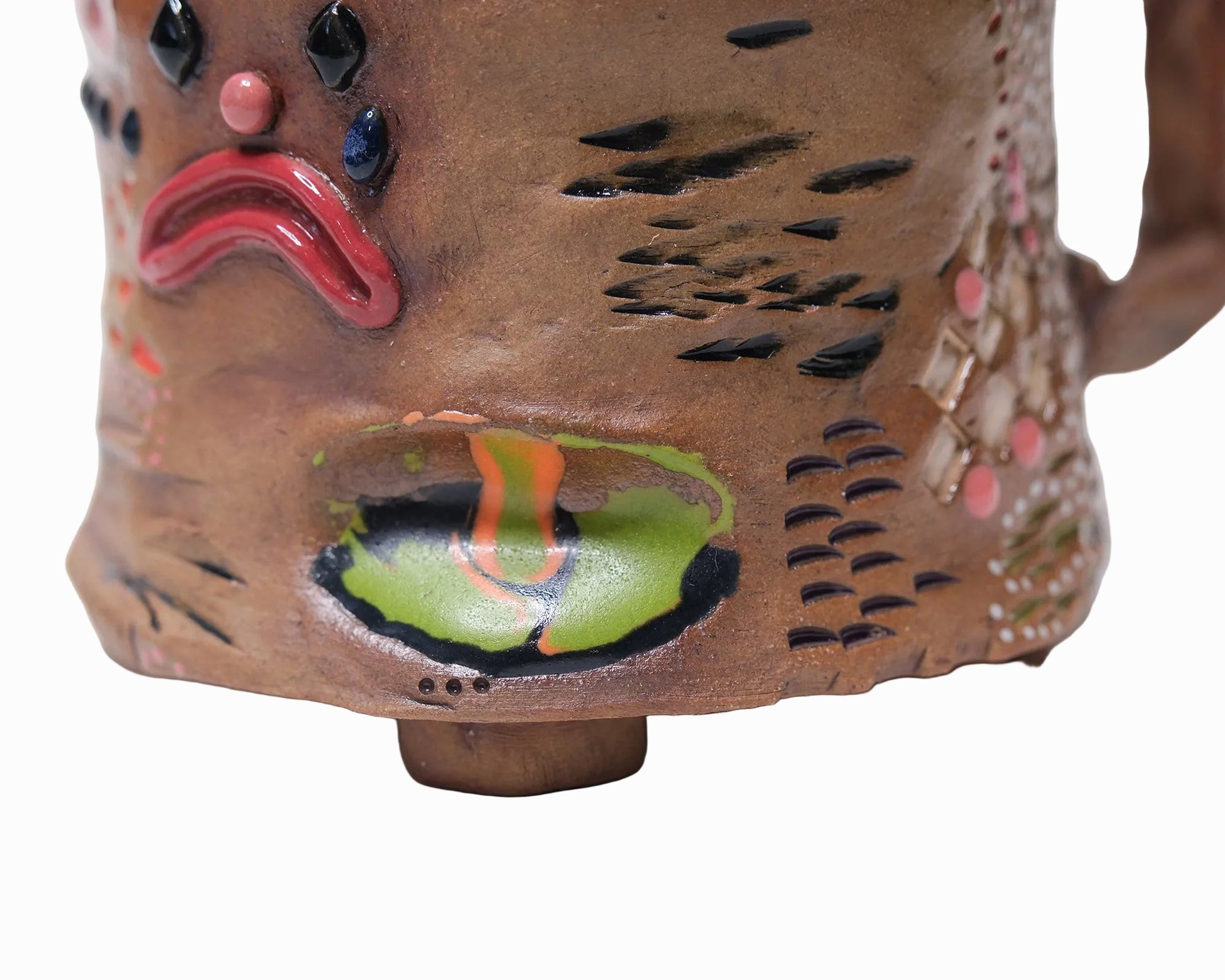 Pictured is a handmade ceramic mug that is full of gloops and globs allowing the mug holder to have a tactile experience while enjoying their preferred drink.
