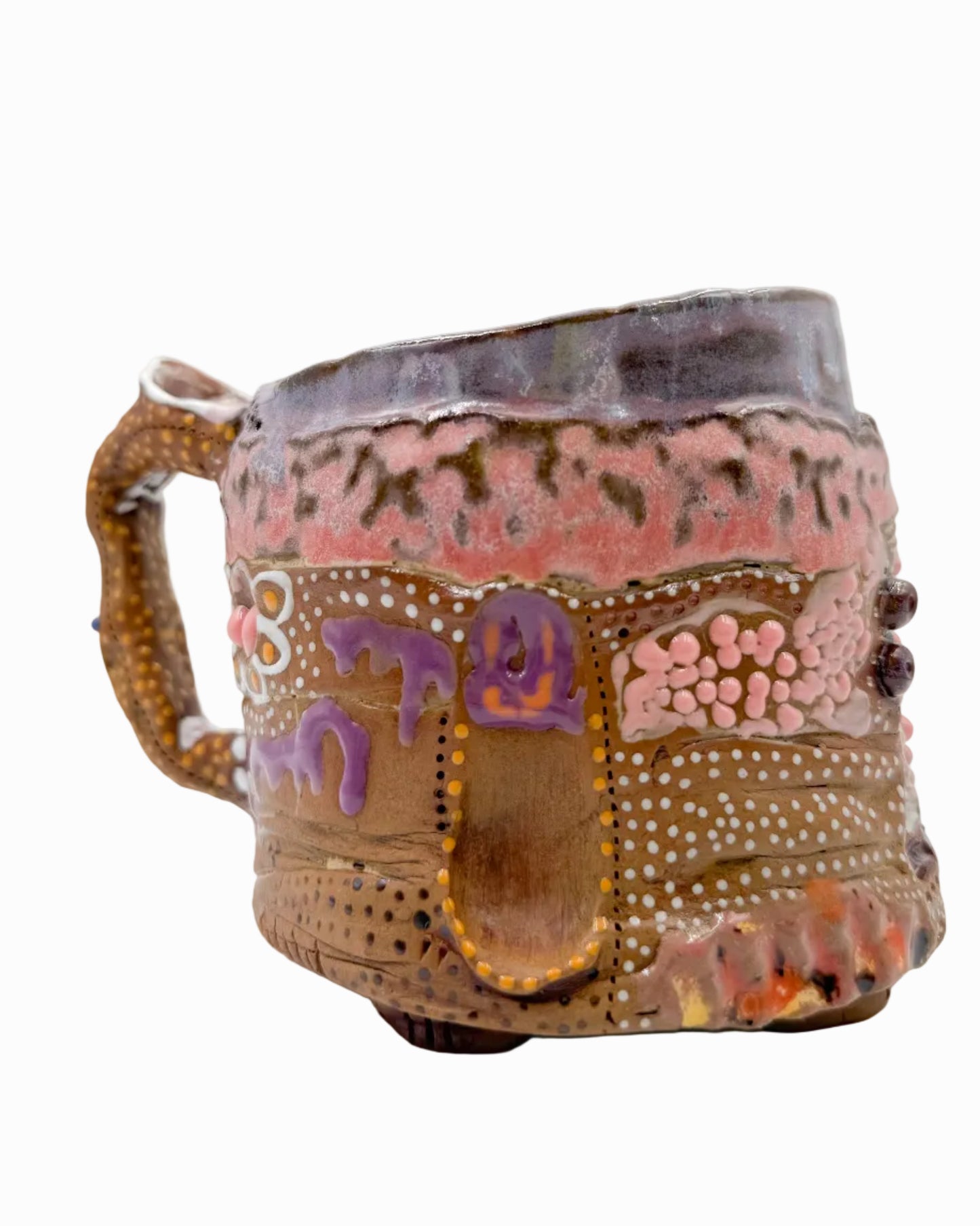 Pictured is a handmade ceramic mug that is full of gloops and globs allowing the mug holder to have a tactile experience while enjoying their preferred drink.
