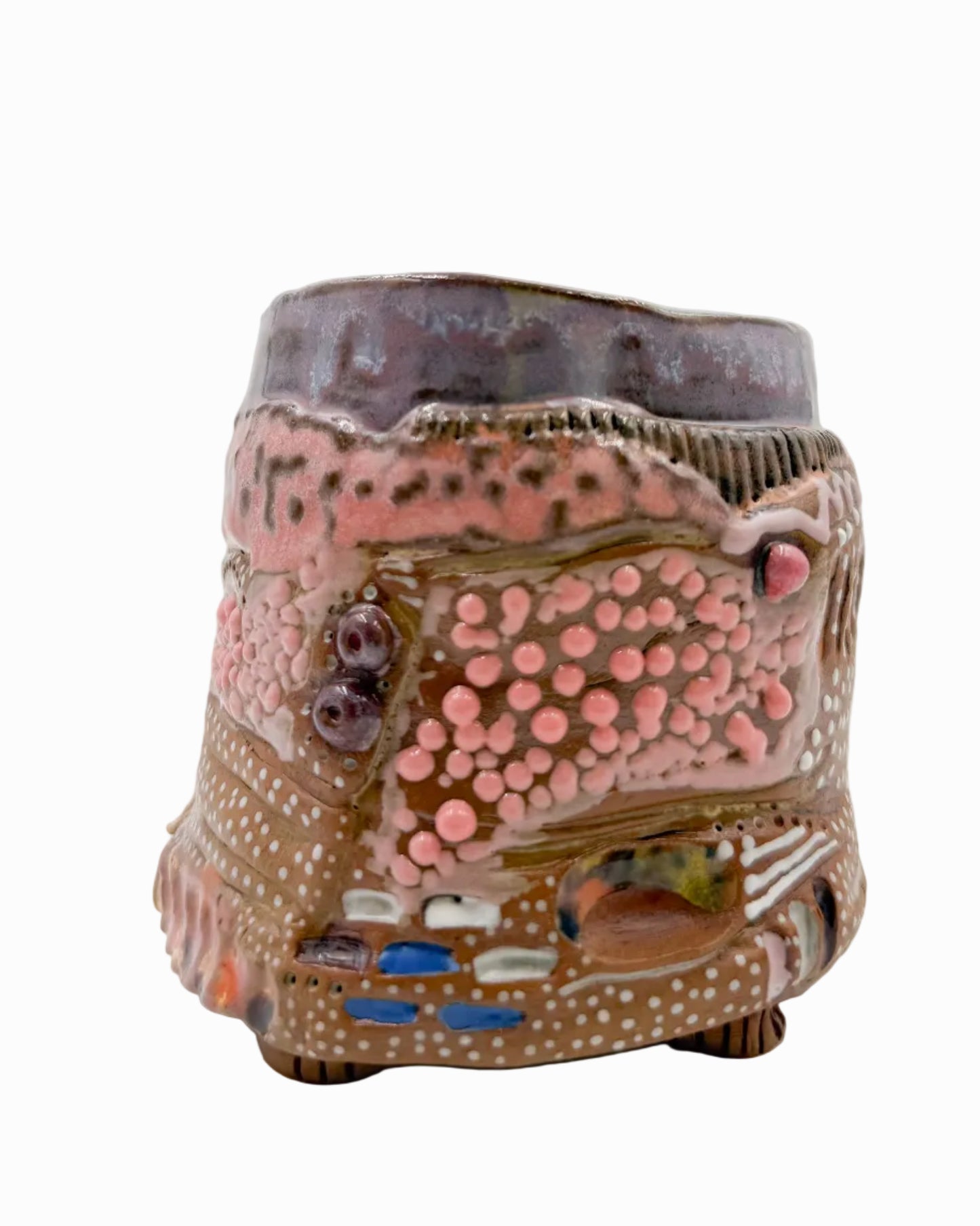 Pictured is a handmade ceramic mug that is full of gloops and globs allowing the mug holder to have a tactile experience while enjoying their preferred drink.
