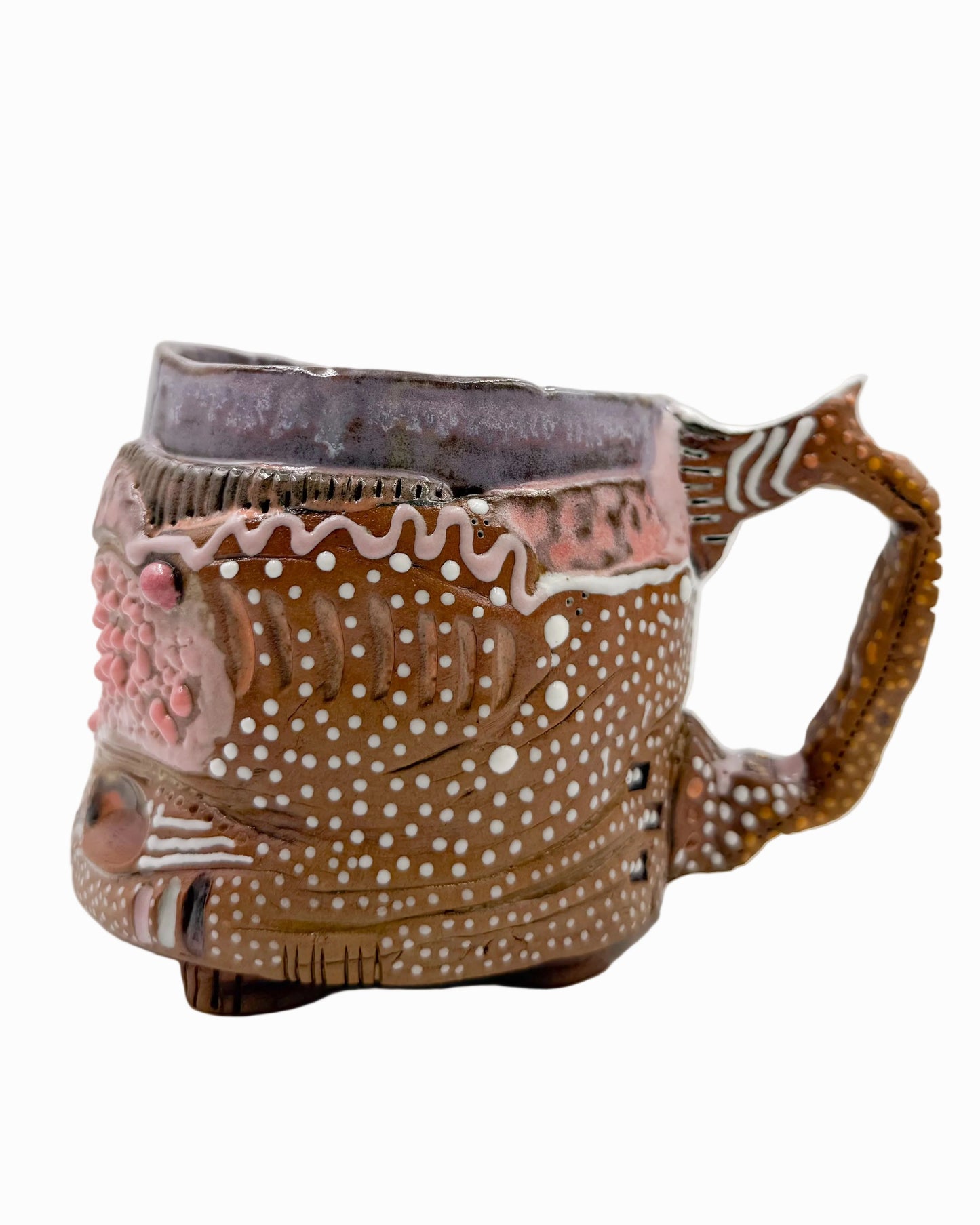 Pictured is a handmade ceramic mug that is full of gloops and globs allowing the mug holder to have a tactile experience while enjoying their preferred drink.
