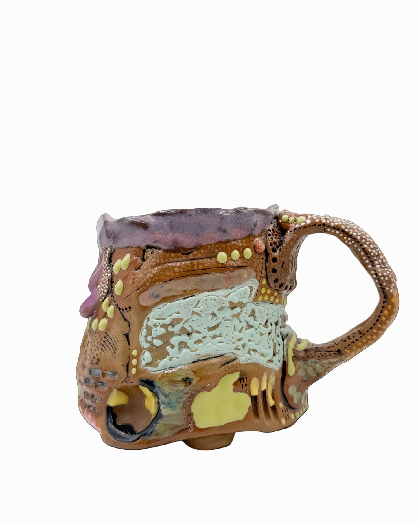 Pictured is a handmade ceramic mug that is full of gloops and globs allowing the mug holder to have a tactile experience while enjoying their preferred drink.
